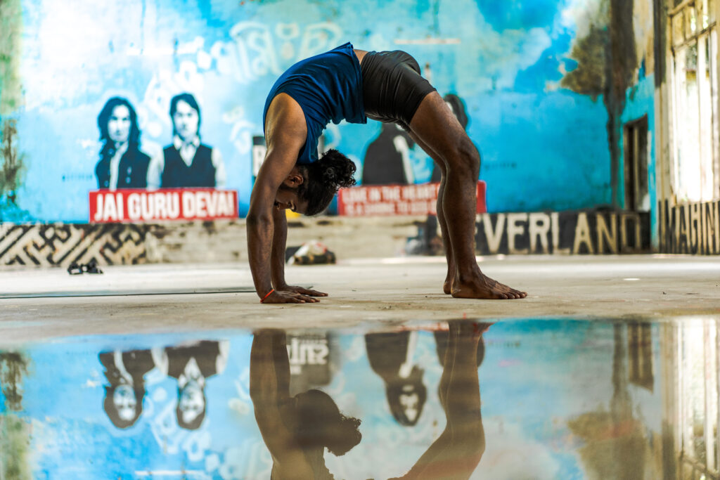 Beginner practicing Ashtanga Yoga at home on a yoga mat while focusing on breath and movement